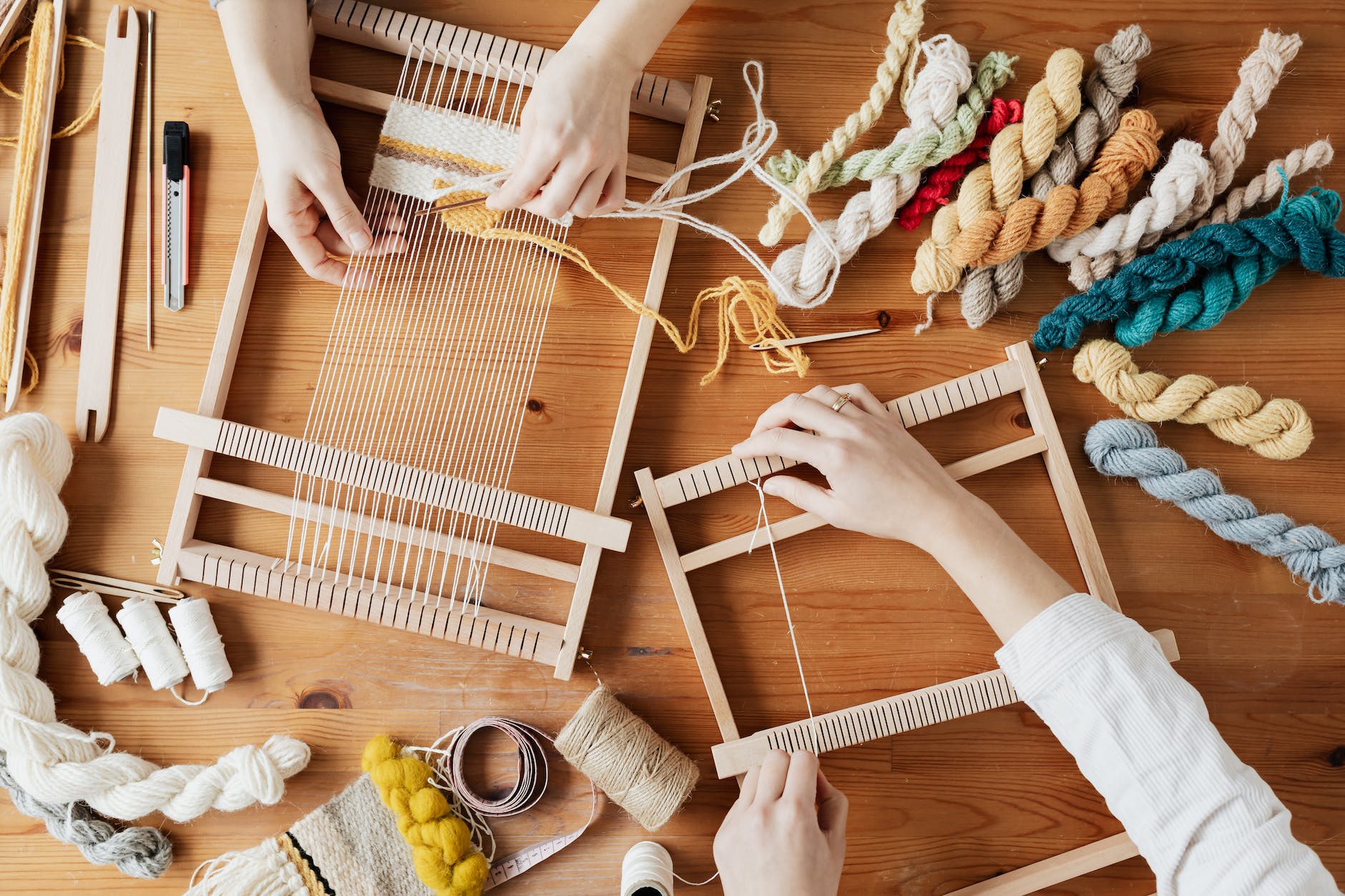 top view photo of two person s hands weaving, idea for DIY decor and crafts that make money