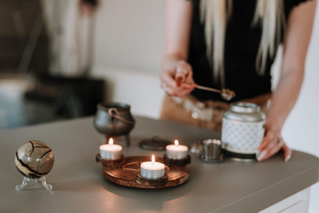 woman preparing scents near shiny candles with any one candle scents names.